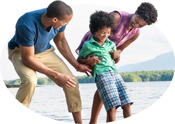 Family of 3 playing together at a lake